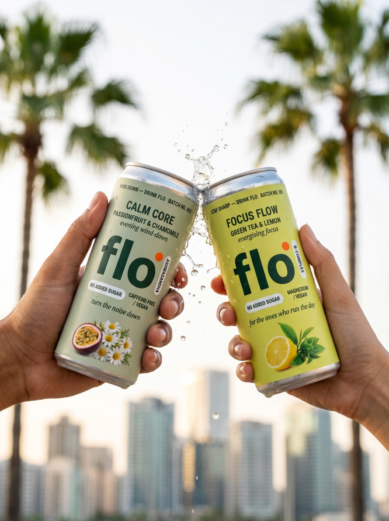 Calm Core and Focus Flow cans clinking together with a splash, palms and city skyline behind
